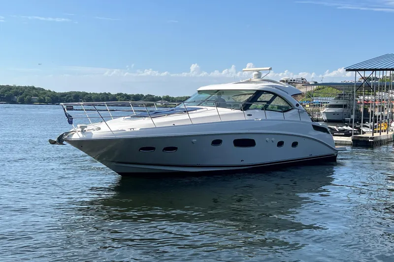 The Image of 2009 Searay 470 Sundancer yacht docked on a sunny day, calm waters. - 1