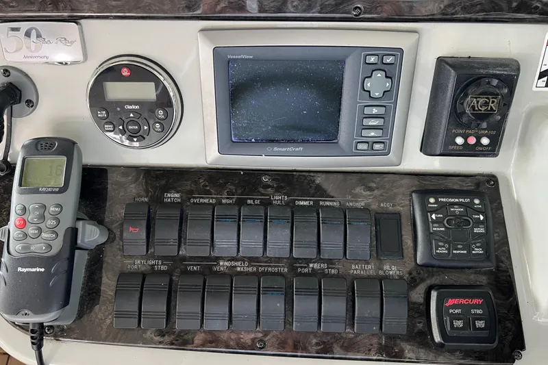 Slide: The Image of Control panel of a 2009 Searay 470 Sundancer boat with navigation and communication equipment. - 12