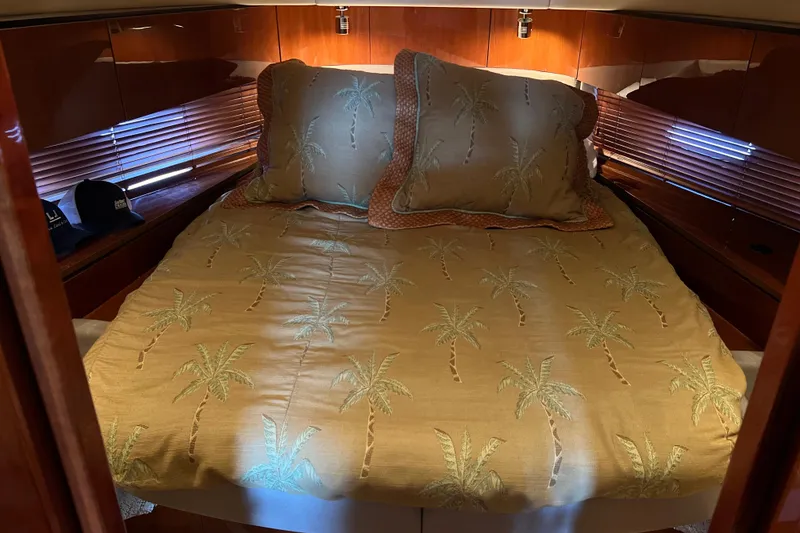 Slide: The Image of Cozy cabin interior of 2009 Searay 470 Sundancer with palm tree bedding. - 14