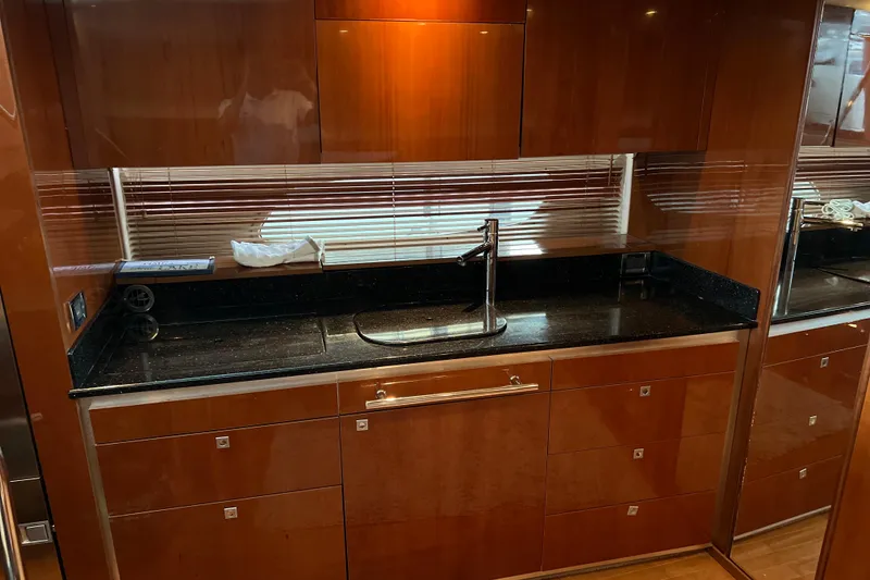 Slide: The Image of Luxurious kitchen interior of 2009 Searay 470 Sundancer yacht with sleek wood cabinetry. - 17