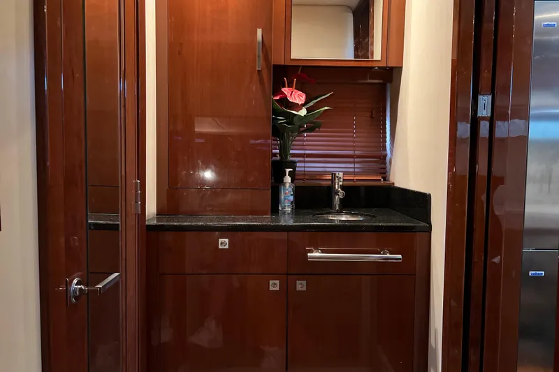 Slide: The Image of Luxurious 2009 Searay 470 Sundancer yacht interior with sleek wooden cabinetry and modern sink. - 19