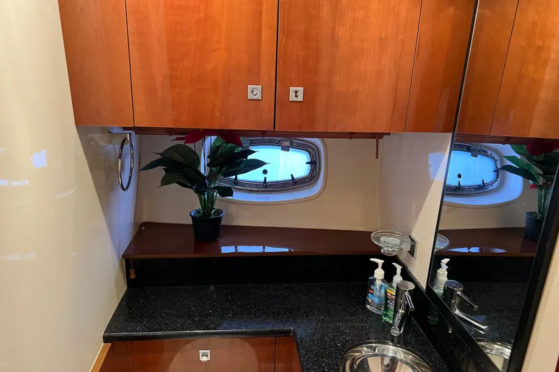 Slide: The Image of Luxurious bathroom interior of 2009 Searay 470 Sundancer yacht with wood cabinets and porthole. - 21