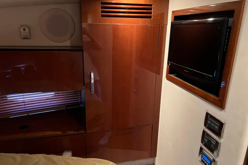 Slide: The Image of Interior of 2009 Searay 470 Sundancer with wood cabinetry and wall-mounted TV. - 25