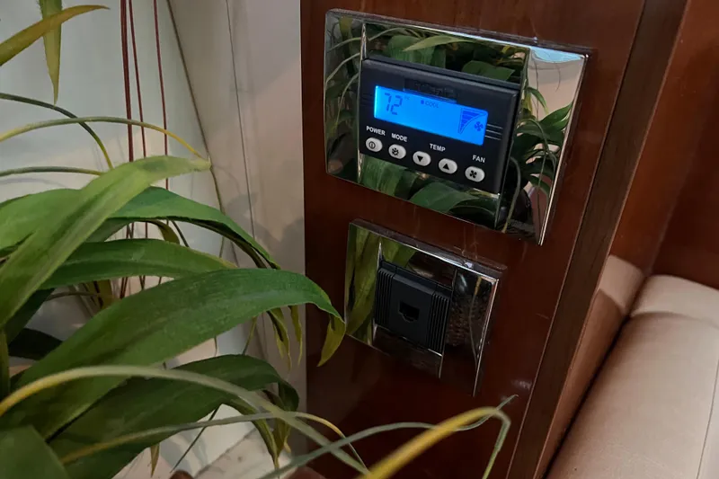 Slide: The Image of Thermostat and control panel on 2009 Searay 470 Sundancer yacht interior. - 32