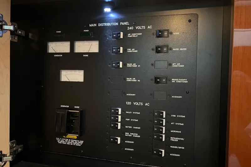 Slide: The Image of Electrical panel of a 2009 Searay 470 Sundancer yacht, showing switches and meters. - 35