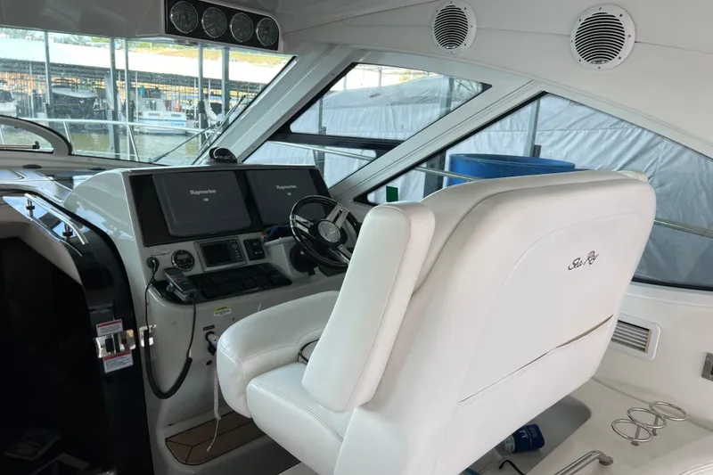 Slide: The Image of Interior helm of 2009 Searay 470 Sundancer yacht with white captain's chair and navigation equipment. - 6