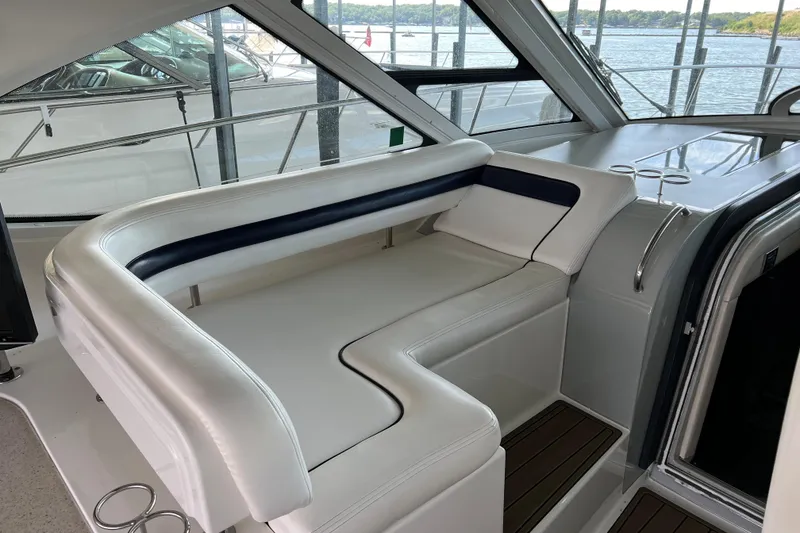 Slide: The Image of 2009 Searay 470 Sundancer yacht interior with white seating and scenic water view. - 7