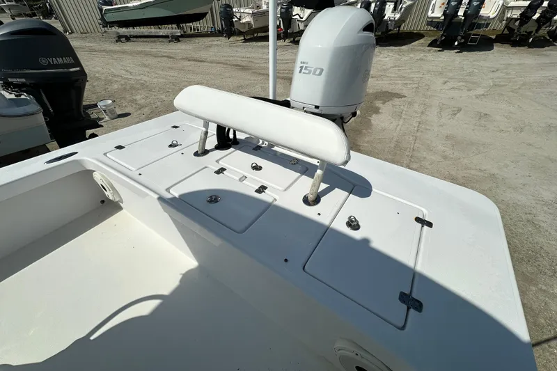 Slide: The Image of 2018 Intruder 23 boat with Yamaha 150 engine, featuring storage compartments and seating. - 14