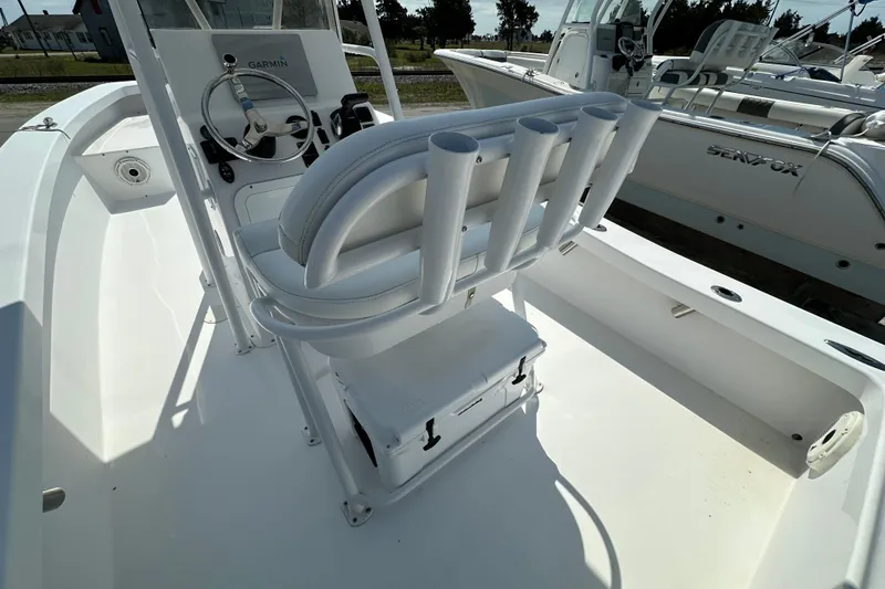 Slide: The Image of 2018 Intruder 23 boat interior with steering wheel and rod holders. - 16