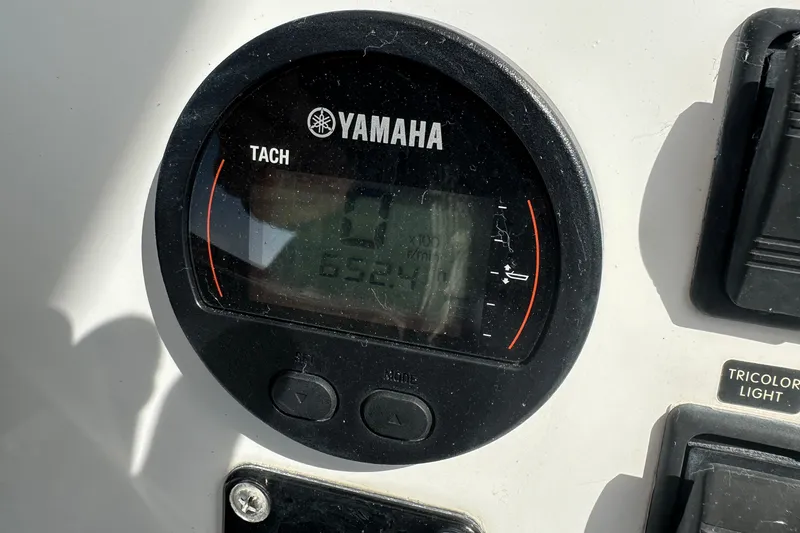 Slide: The Image of Yamaha tachometer on 2018 Intruder 23 boat dashboard, displaying engine RPM. - 18