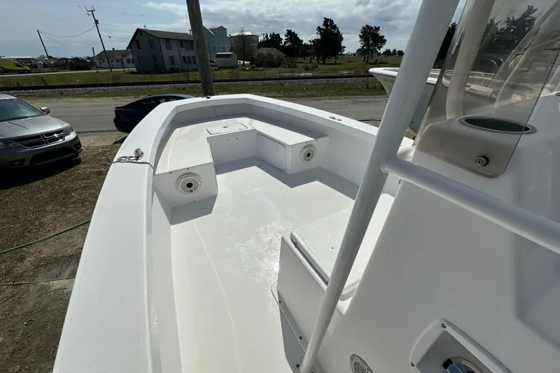 Slide: The Image of 2018 Intruder 23 boat deck with seating, parked near road and vehicles. - 5