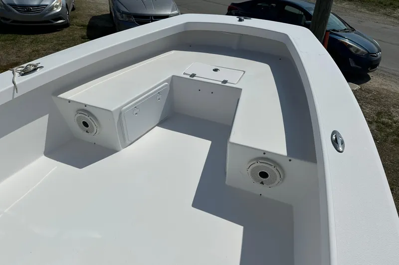 Slide: The Image of 2018 Intruder 23 boat interior with storage compartments and speakers. - 6