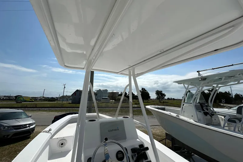 Slide: The Image of 2018 Intruder 23 boat with Garmin equipment, parked outdoors under a clear sky. - 8