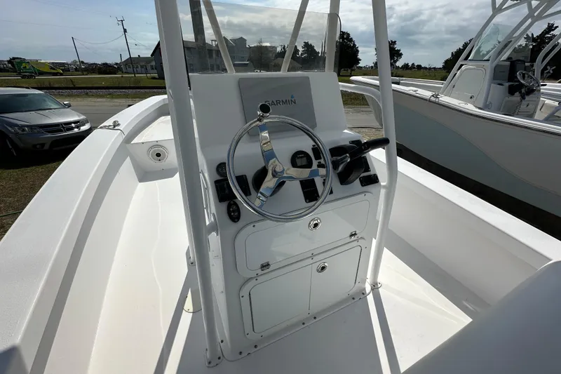 Slide: The Image of 2018 Intruder 23 boat console with steering wheel and Garmin navigation system. - 9