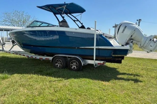 Slide: The Image of 2022 Cobalt R8 Outboard boat on trailer, blue exterior, parked on grass. - 1