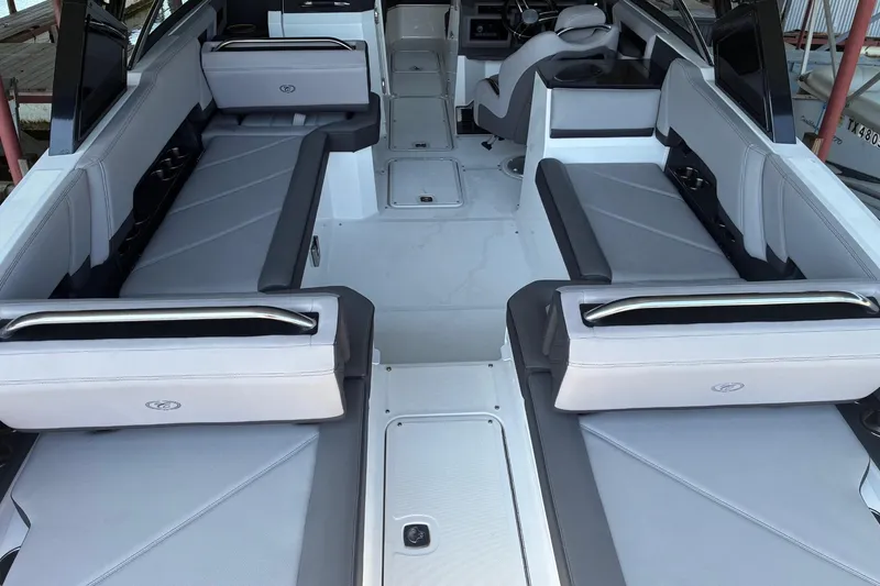 Slide: The Image of 2022 Cobalt R8 Outboard boat storage compartment with cup holders and sleek design. - 13