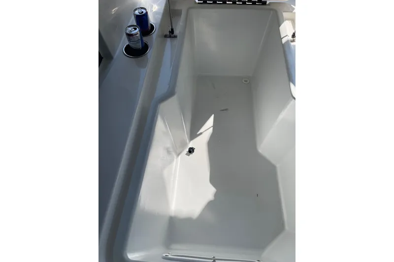 Slide: The Image of Interior compartment of 2022 Cobalt R8 Outboard boat, featuring storage space and piping. - 15