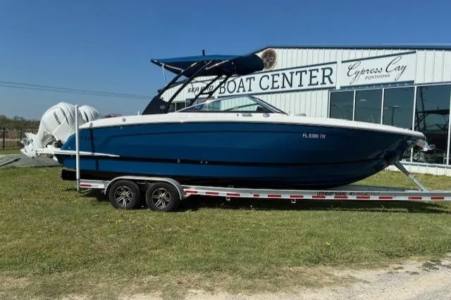 Slide: The Image of 2022 Cobalt R8 Outboard boat with Yamaha engine, parked outdoors near a building. - 2