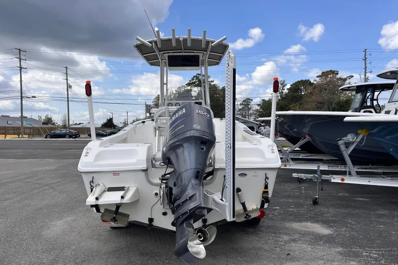 Slide: The Image of 2012 Tidewater 216 CC Adventure boat with Yamaha outboard motor, parked outdoors. - 4