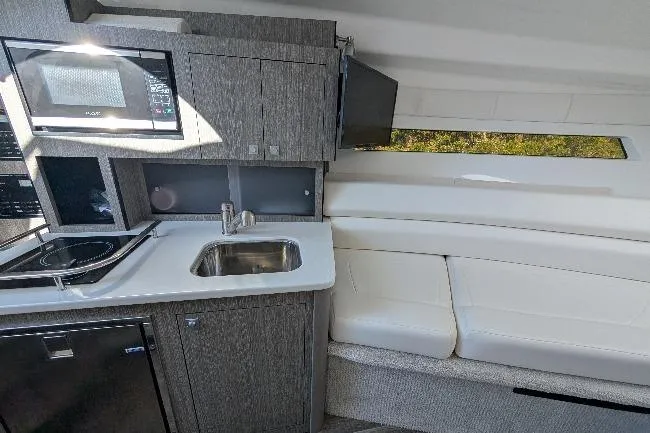 Slide: The Image of Interior of 2022 Monterey 295SS Super Sport boat with kitchenette and seating area. - 18