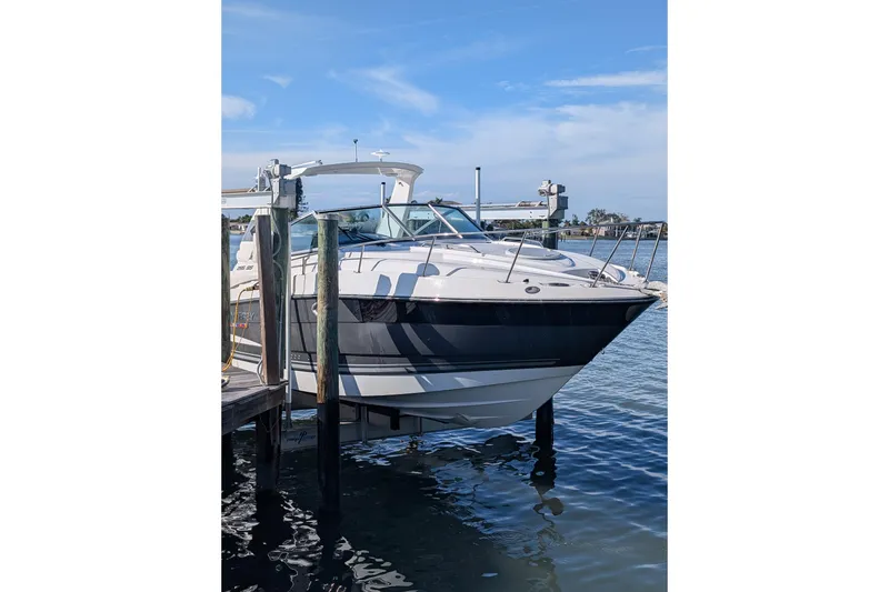 Slide: The Image of 2022 Monterey 295SS Super Sport boat docked on a sunny day. - 2