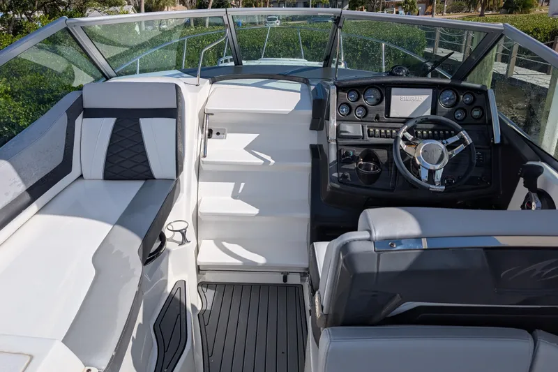 Slide: The Image of 2022 Monterey 295SS Super Sport boat interior with sleek dashboard and seating. - 21
