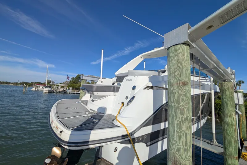 Slide: The Image of 2022 Monterey 295SS Super Sport boat docked on a sunny day. - 4