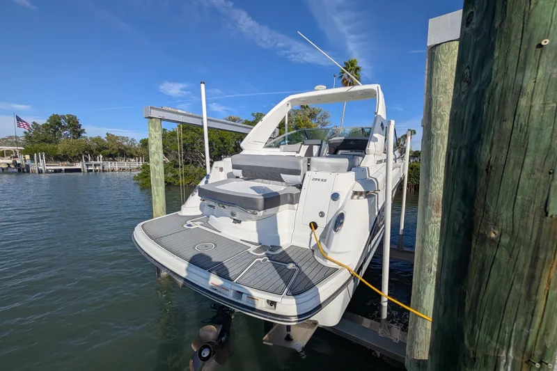 Slide: The Image of 2022 Monterey 295SS Super Sport boat docked on a sunny day. - 5
