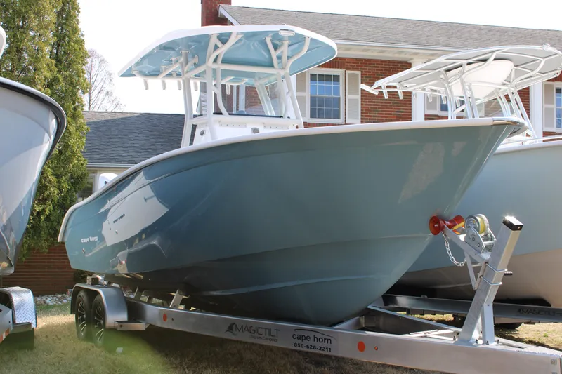 The Image of 2026 Cape Horn 24 XS boat on trailer in front of brick building. - 1