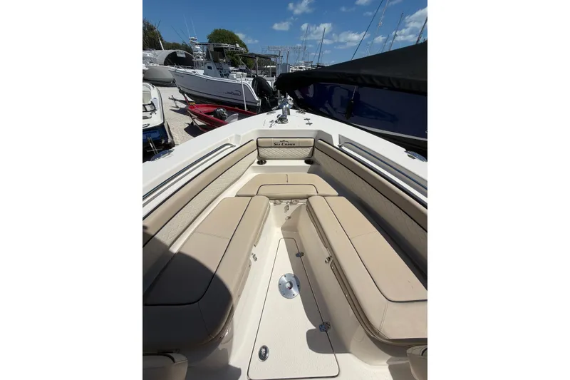 Slide: The Image of 2022 Sea Chaser 22 HFC boat interior with beige seating and open deck. - 11