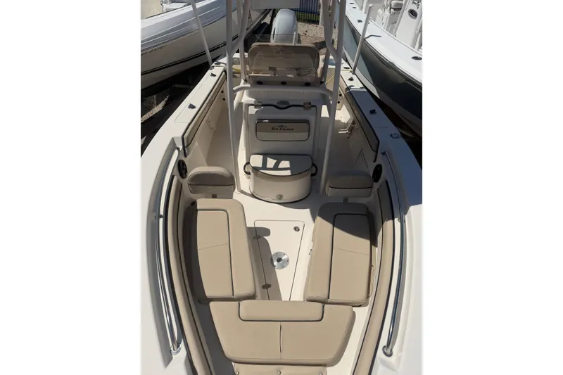 Slide: The Image of 2022 Sea Chaser 22 HFC boat interior with beige seating and console. - 12