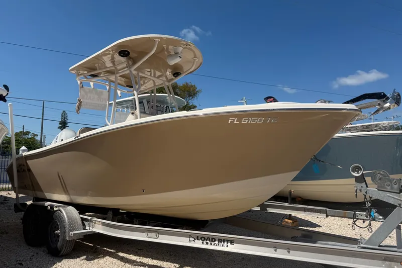 Slide: The Image of 2022 Sea Chaser 22 HFC boat on trailer under clear blue sky. - 2