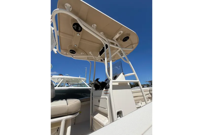 Slide: The Image of 2022 Sea Chaser 22 HFC boat interior with T-top and seating, under clear blue sky. - 4