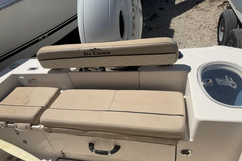 Slide: The Image of 2022 Sea Chaser 22 HFC boat interior with beige seating and storage compartments. - 7