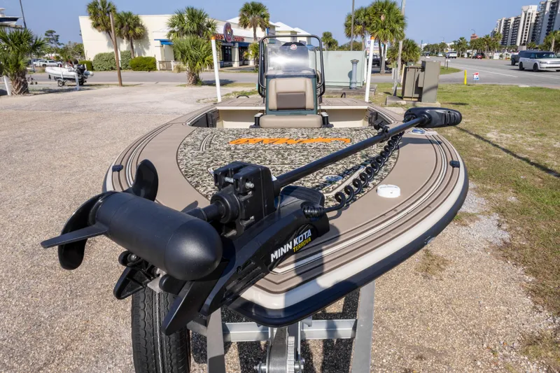 Slide: The Image of 2025 Mako 18 Pro Skiff Backwater Edition with Minn Kota trolling motor, parked outdoors. - 10