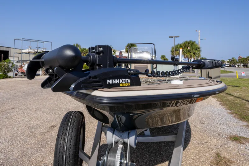 Slide: The Image of 2025 Mako 18 Pro Skiff Backwater Edition with Minn Kota Terrova motor, parked outdoors. - 11