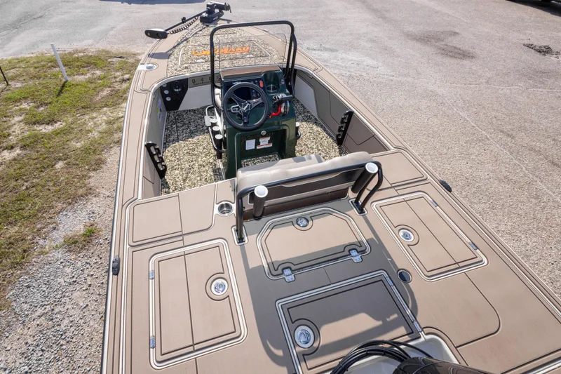 Slide: The Image of 2025 Mako 18 Pro Skiff Backwater Edition boat with spacious deck and modern controls. - 18