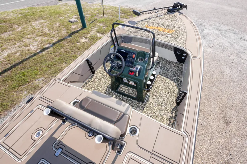 Slide: The Image of 2025 Mako 18 Pro Skiff Backwater Edition boat interior with steering console and seating. - 19