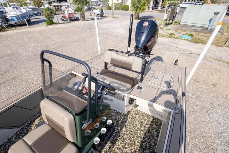 Slide: The Image of 2025 Mako 18 Pro Skiff Backwater Edition boat with seating and outboard motor. - 22