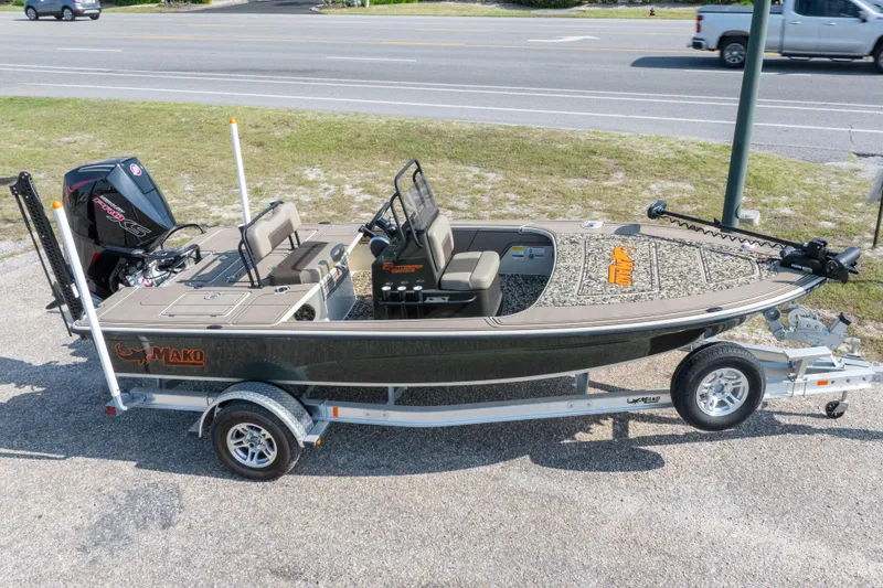 Slide: The Image of 2025 Mako 18 Pro Skiff Backwater Edition boat on trailer, parked outdoors. - 30