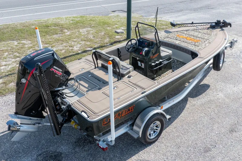 Slide: The Image of 2025 Mako 18 Pro Skiff Backwater Edition boat on trailer, featuring sleek design and powerful engine. - 31