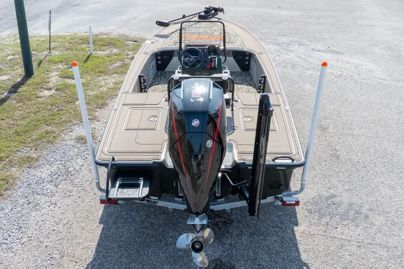 Slide: The Image of 2025 Mako 18 Pro Skiff Backwater Edition boat, rear view with motor and deck. - 32