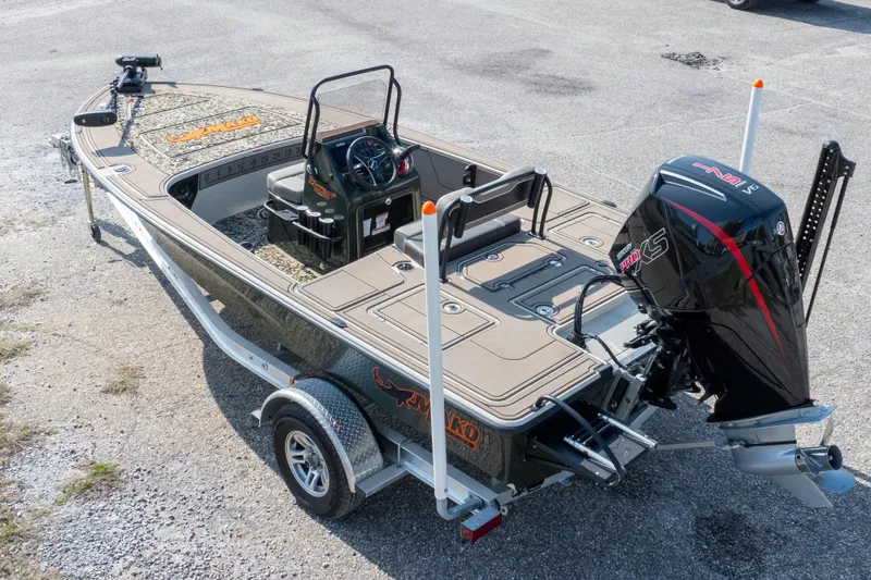 Slide: The Image of 2025 Mako 18 Pro Skiff Backwater Edition boat with powerful outboard motor on trailer. - 33