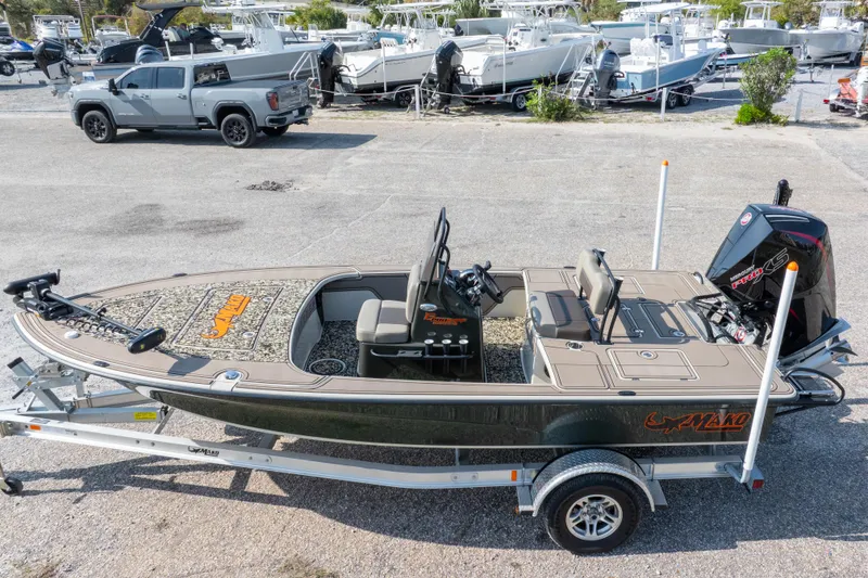Slide: The Image of 2025 Mako 18 Pro Skiff Backwater Edition boat on trailer in marina setting. - 34
