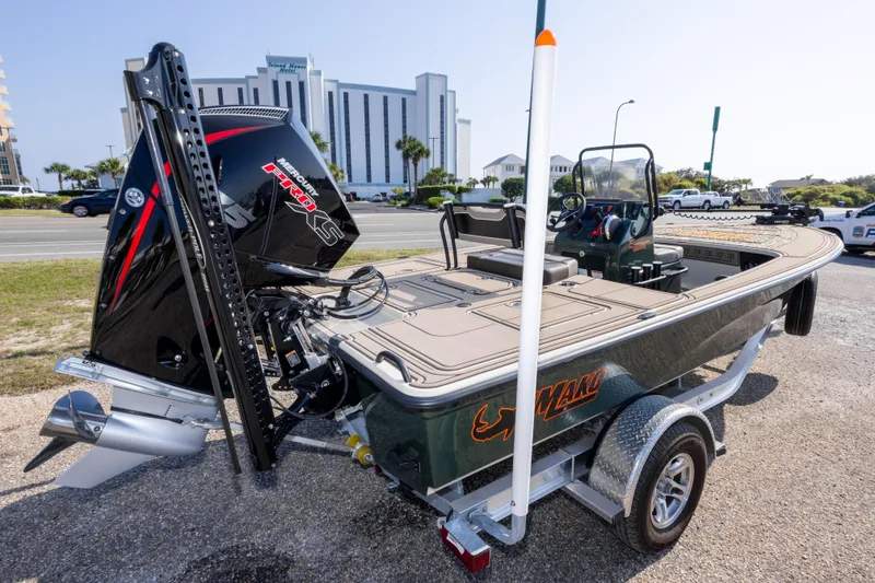 Slide: The Image of 2025 Mako 18 Pro Skiff Backwater Edition boat on trailer, parked near a road. - 5