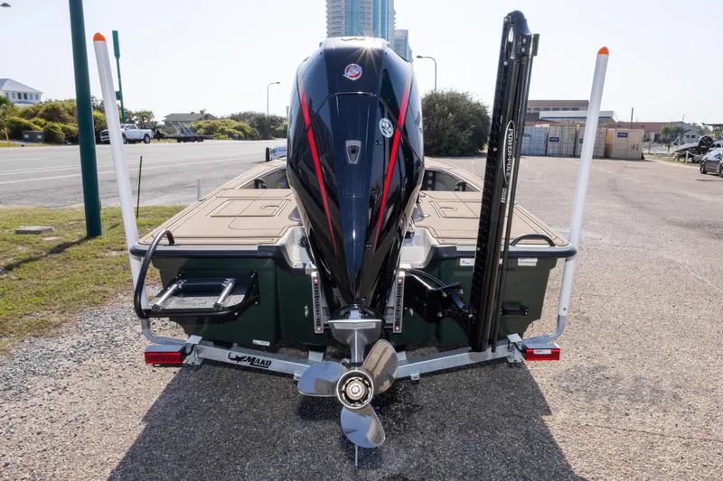 Slide: The Image of 2025 Mako 18 Pro Skiff Backwater Edition with powerful outboard motor, parked on a trailer. - 6