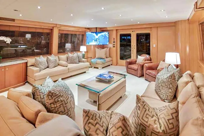 Slide: The Image of Luxurious Crescent Custom Yacht interior with elegant dining area, striped cushions, and polished wood table. - 2