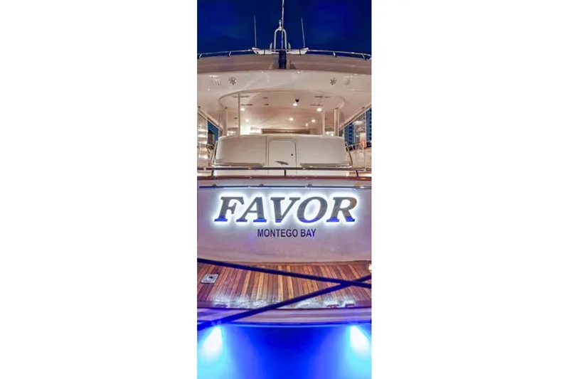 Slide: The Image of Luxurious Crescent Custom Yacht deck with striped chairs and wooden table, 2000 model, evening view. - 20