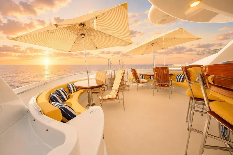 Slide: The Image of Luxurious Crescent Custom Yacht deck with seating, umbrellas, and ocean sunset view, year 2000. - 47
