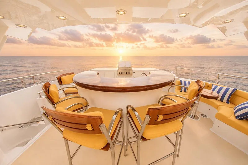 Slide: The Image of Luxurious Crescent Custom Yacht deck with bar seating, ocean view, and sunset ambiance, year 2000. - 49